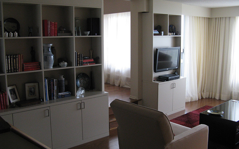 Photo of a small classic open plan living room in Ottawa with beige walls, medium hardwood flooring and a built-in media unit.