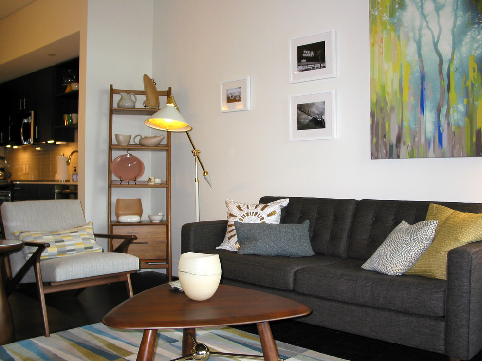 Small mid-century modern open concept dark wood floor living room photo in Seattle with white walls and a tv stand