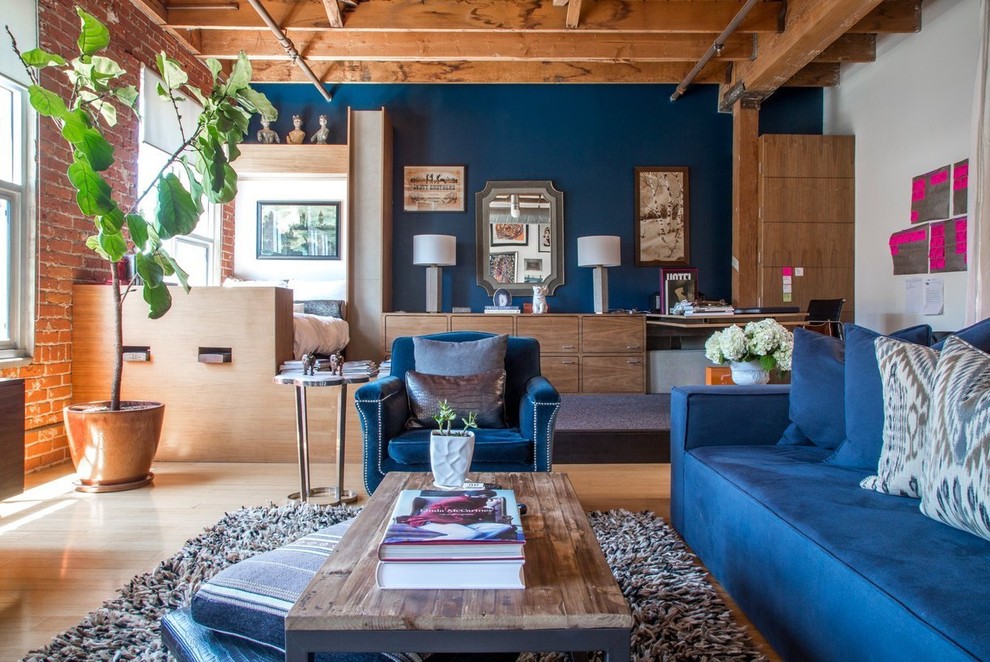 Inspiration for an industrial open concept light wood floor living room remodel in Los Angeles with blue walls