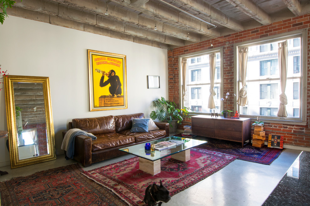 Photo of an urban living room in Los Angeles with white walls and concrete flooring.