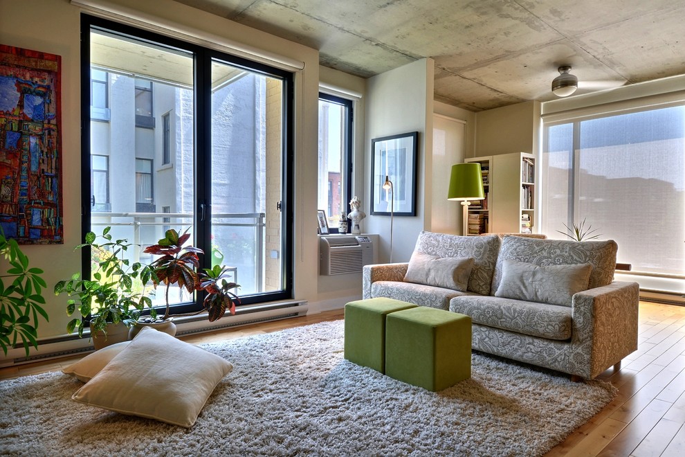 Living room - contemporary open concept medium tone wood floor living room idea in Montreal with beige walls