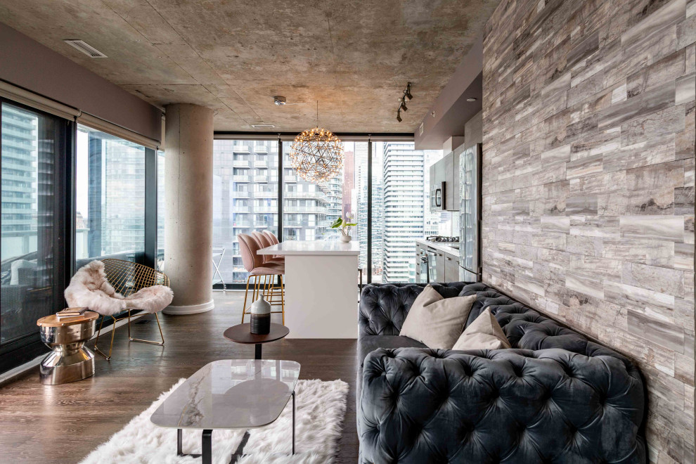 Industrial open plan living room in Toronto with grey walls, dark hardwood flooring and brown floors.