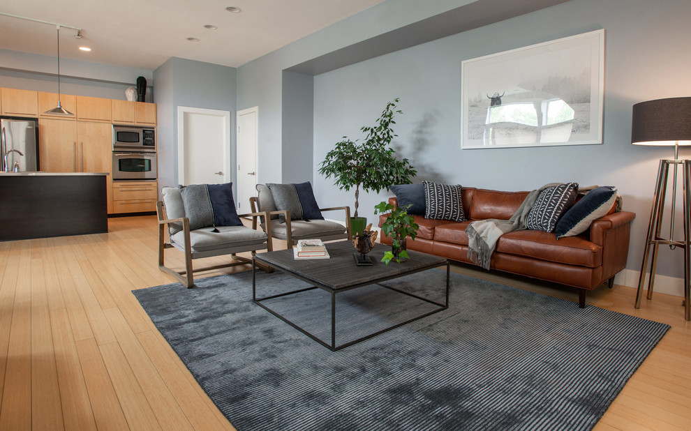 Foto de salón para visitas tipo loft actual de tamaño medio sin chimenea y televisor con paredes azules y suelo de madera en tonos medios