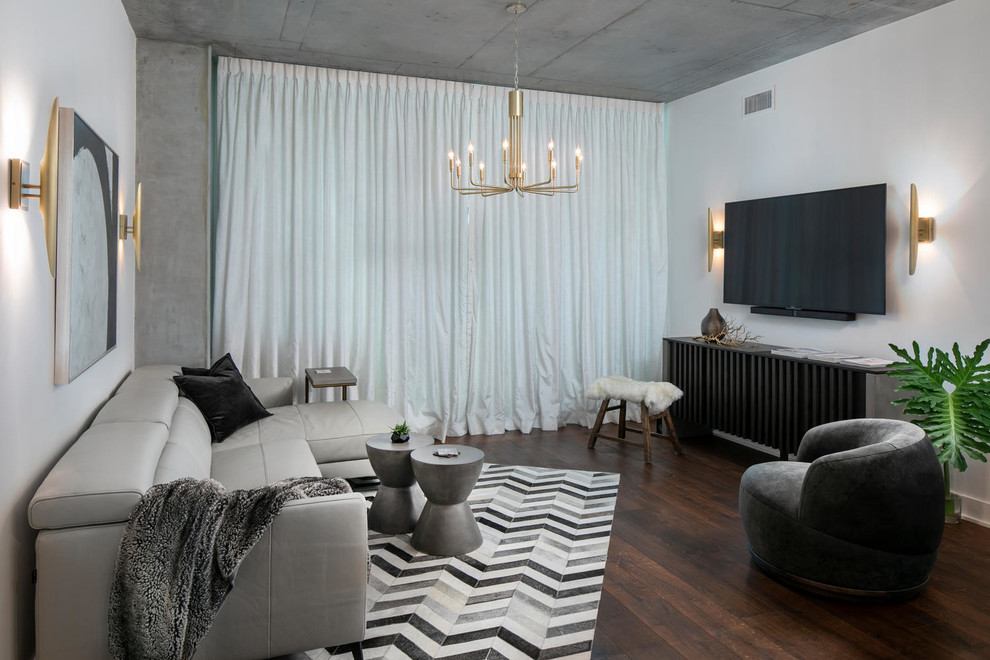 Idée de décoration pour un salon design de taille moyenne et ouvert avec un mur blanc, parquet foncé et un sol marron.