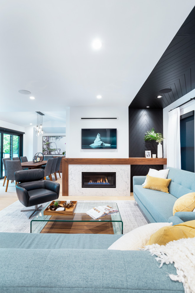 Large contemporary open plan living room in Vancouver with white walls, light hardwood flooring, a ribbon fireplace, a wall mounted tv, beige floors, tongue and groove walls and a stone fireplace surround.