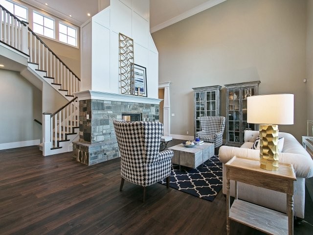 This is an example of a medium sized classic formal open plan living room in Salt Lake City with grey walls, medium hardwood flooring, a stone fireplace surround, no tv and a two-sided fireplace.