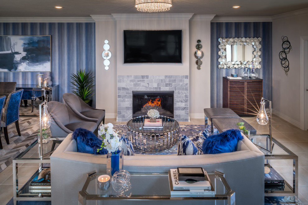 Идея дизайна: парадная, открытая гостиная комната среднего размера в стиле модернизм с синими стенами, полом из керамической плитки, стандартным камином и телевизором на стене
