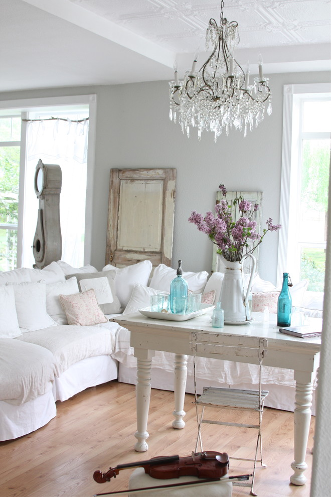 Example of a cottage chic living room design in Other with gray walls