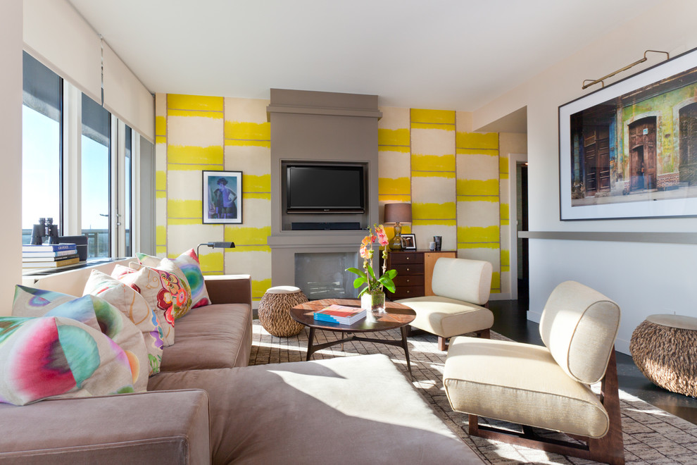 Example of a large trendy open concept dark wood floor and brown floor living room design in New York with a standard fireplace, a wall-mounted tv, white walls and a plaster fireplace