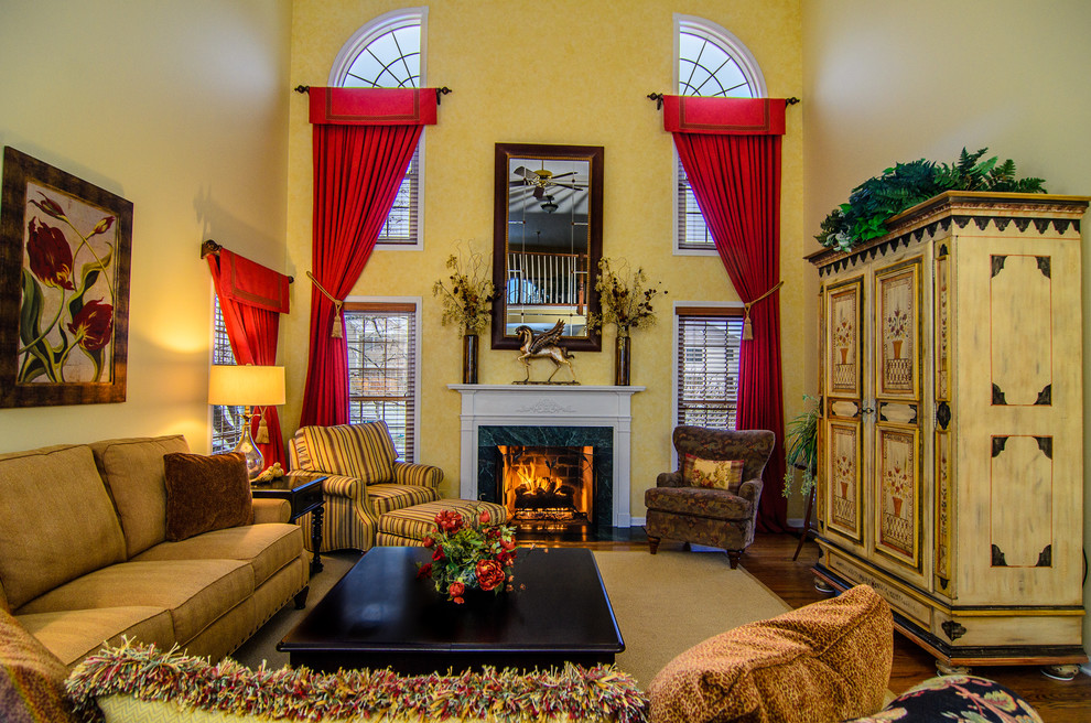 Aménagement d'un grand salon classique ouvert avec un mur jaune, une cheminée standard, une salle de réception, un sol en bois brun et un téléviseur dissimulé.