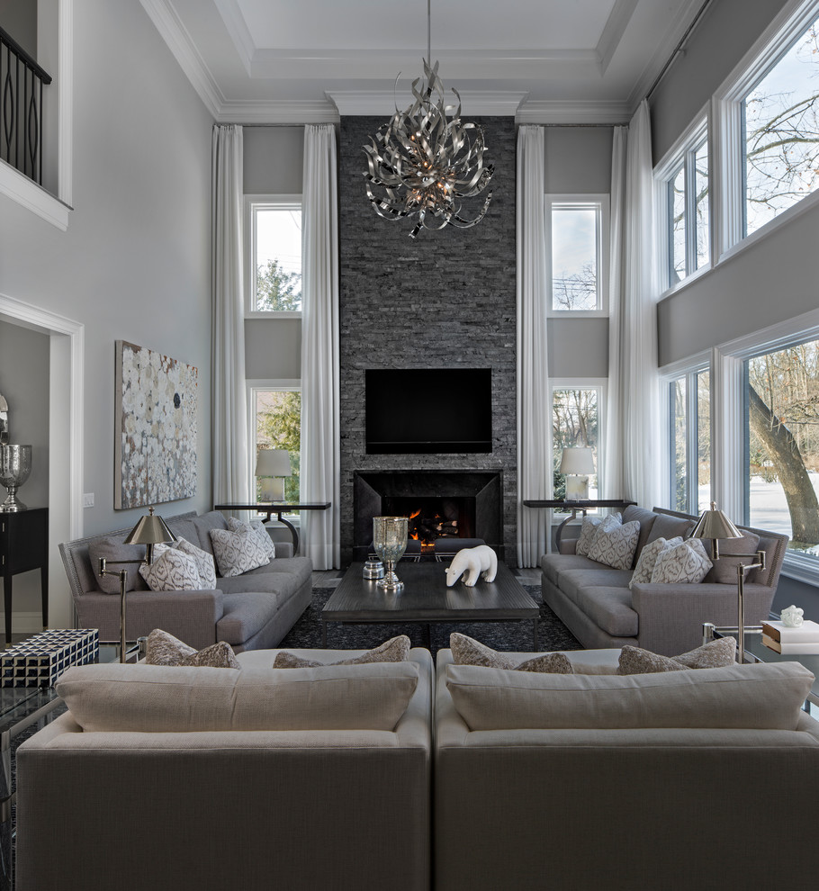 Design ideas for an expansive classic open plan living room in Detroit with grey walls, medium hardwood flooring, a standard fireplace, a stone fireplace surround and a wall mounted tv.