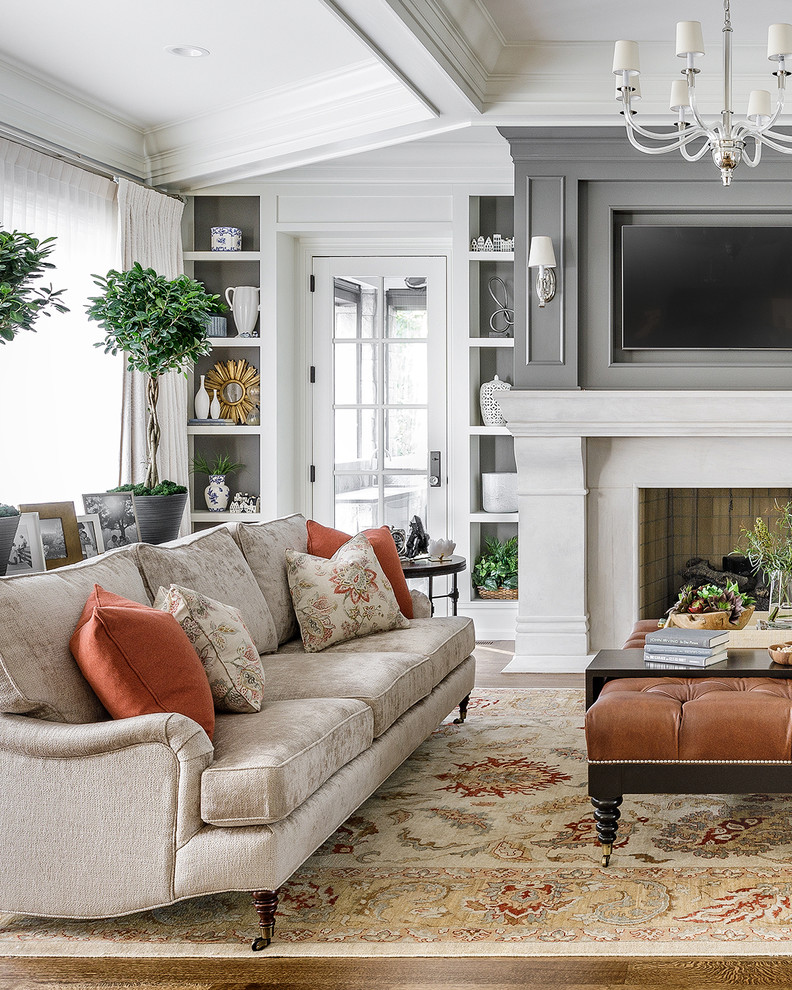 Living room - large transitional open concept medium tone wood floor and brown floor living room idea in Chicago with gray walls, a standard fireplace and a wall-mounted tv