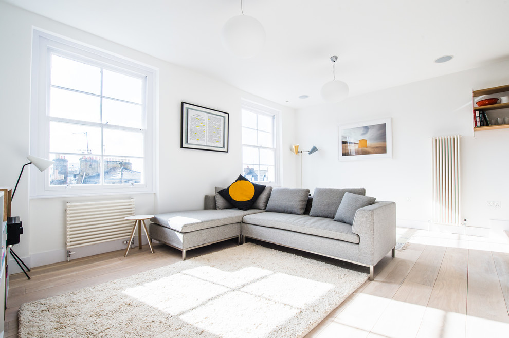 Mittelgroßes, Offenes Modernes Wohnzimmer mit weißer Wandfarbe und hellem Holzboden in London