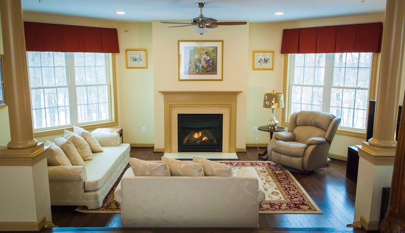 Design ideas for a large traditional formal enclosed living room in Baltimore with beige walls, dark hardwood flooring, a standard fireplace, a wooden fireplace surround and no tv.