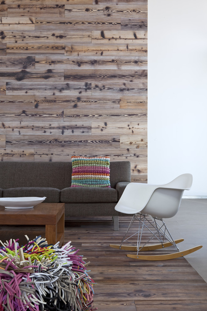 This is an example of a modern living room in San Diego with dark hardwood flooring.