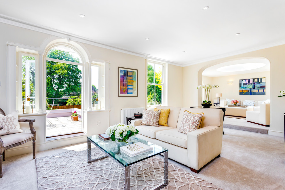 Transitional carpeted living room photo in London with beige walls