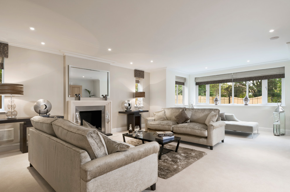 Design ideas for a medium sized contemporary formal living room in Buckinghamshire with beige walls, carpet, a standard fireplace, a metal fireplace surround, beige floors and no tv.