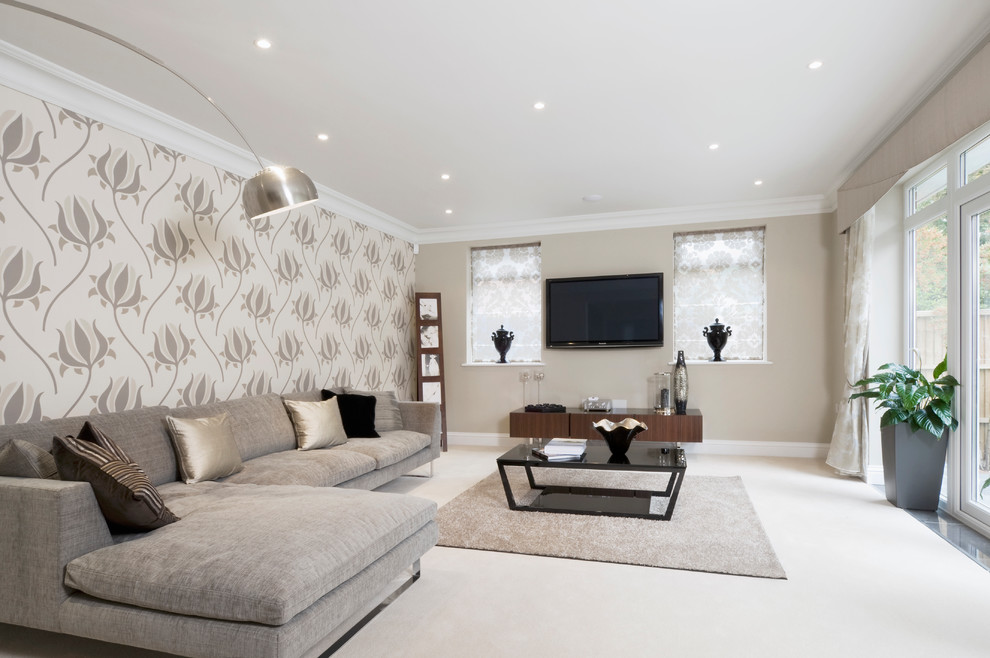 Medium sized contemporary living room in Buckinghamshire with beige walls, carpet, no fireplace, a wall mounted tv and beige floors.