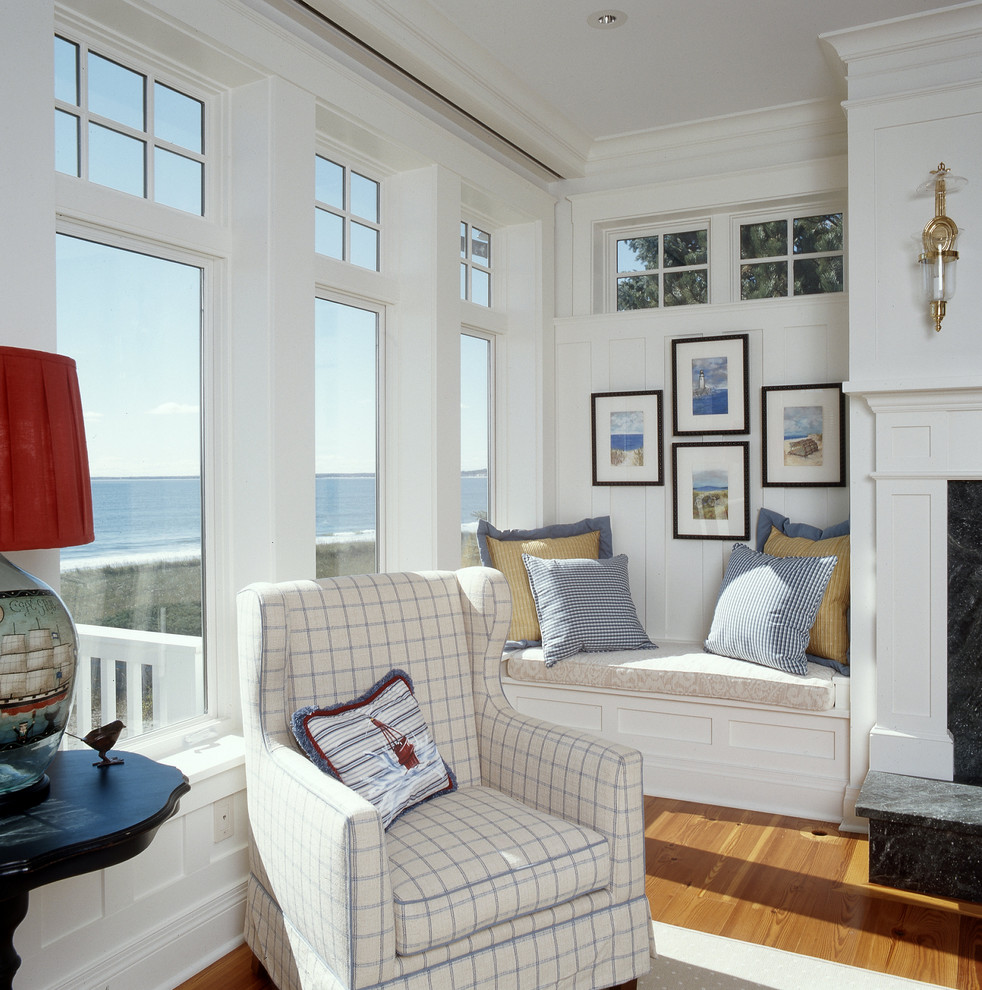 Photo of a coastal living room in Portland Maine with white walls and medium hardwood flooring.
