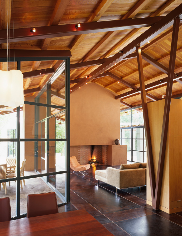 This is an example of a contemporary open plan living room in San Francisco with beige walls, a standard fireplace, a plastered fireplace surround and brown floors.