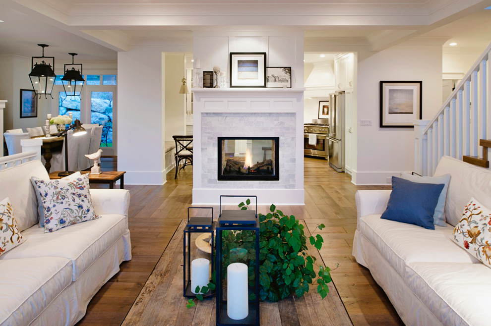 Design ideas for a large coastal open plan living room in Vancouver with light hardwood flooring, a two-sided fireplace and a tiled fireplace surround.