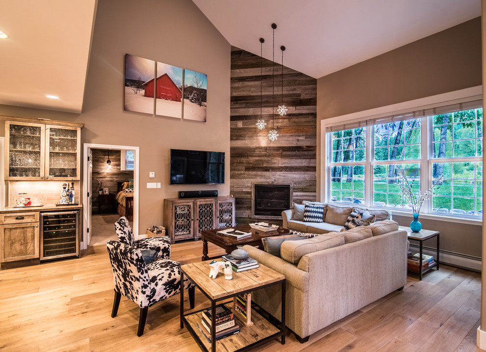 Medium sized classic open plan living room in Denver with beige walls, light hardwood flooring, a standard fireplace, a wooden fireplace surround and a wall mounted tv.