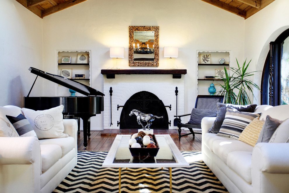 Mid-sized tuscan living room photo in Los Angeles with a music area and a brick fireplace