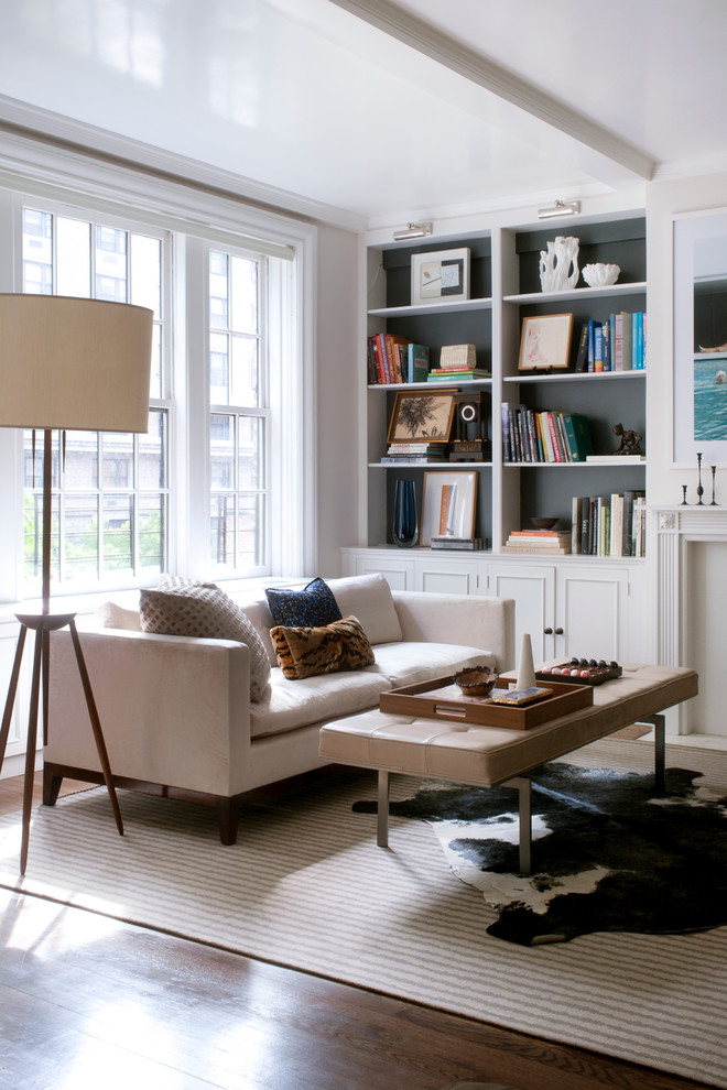 Inspiration for a transitional living room remodel in New York with a standard fireplace