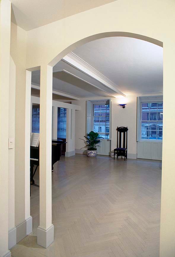 На фото: огромная открытая гостиная комната в стиле модернизм с белыми стенами, светлым паркетным полом, стандартным камином, фасадом камина из камня и мультимедийным центром