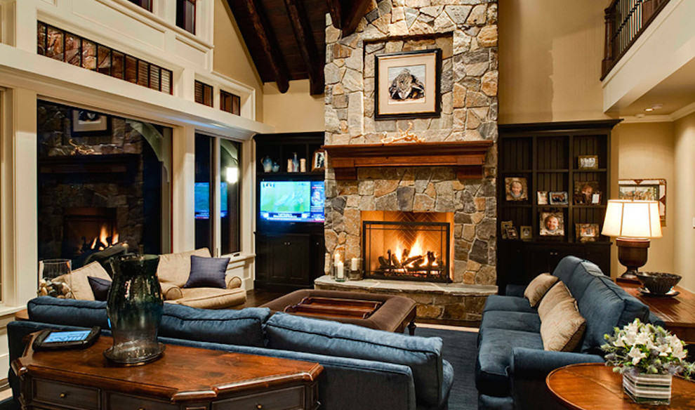 Medium sized classic enclosed living room in Other with beige walls, dark hardwood flooring, a standard fireplace, a stone fireplace surround, a built-in media unit and brown floors.