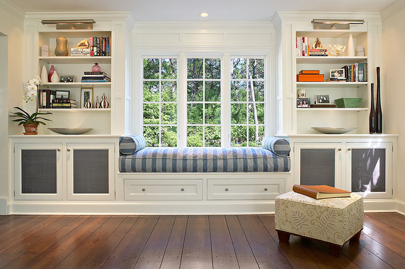 Living room library - mid-sized traditional enclosed dark wood floor living room library idea in New York with white walls