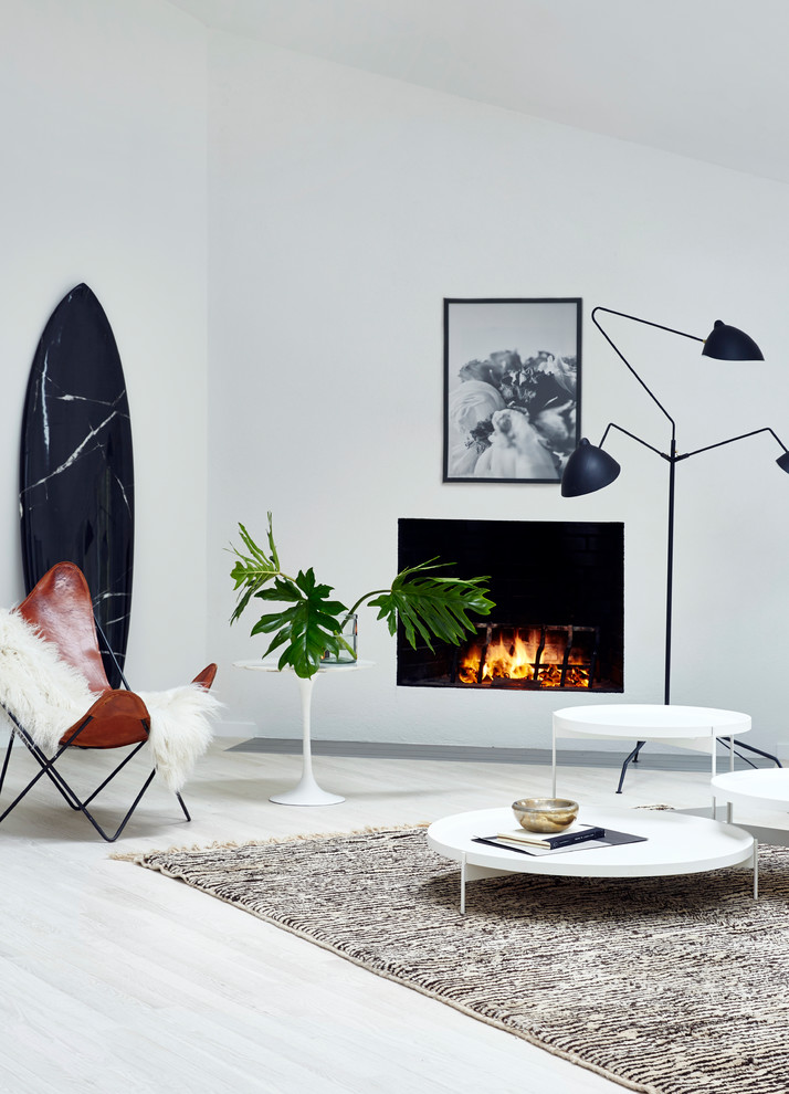 Design ideas for a medium sized scandi formal open plan living room in New York with white walls, light hardwood flooring, a standard fireplace, a plastered fireplace surround, no tv and beige floors.