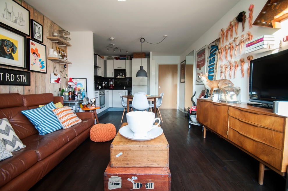 Example of a mid-sized eclectic formal and open concept dark wood floor living room design in London with white walls, a tv stand and no fireplace