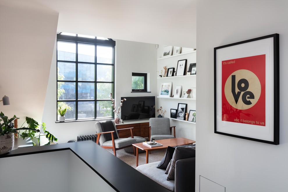 Idéer för ett mellanstort modernt vardagsrum, med vita väggar, ljust trägolv, en fristående TV och beiget golv