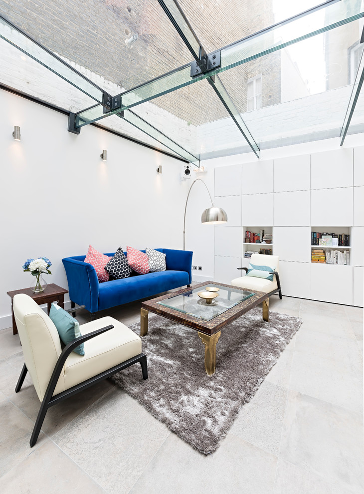 This is an example of a medium sized contemporary enclosed living room in London with white walls and grey floors.