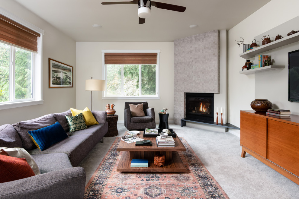 Inspiration for a mid-sized contemporary open concept carpeted and gray floor living room remodel in Seattle with white walls, a corner fireplace, a tile fireplace and a wall-mounted tv