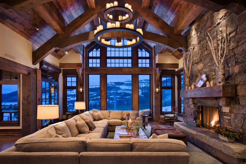 Example of a mountain style living room design in Other with a standard fireplace and a stone fireplace