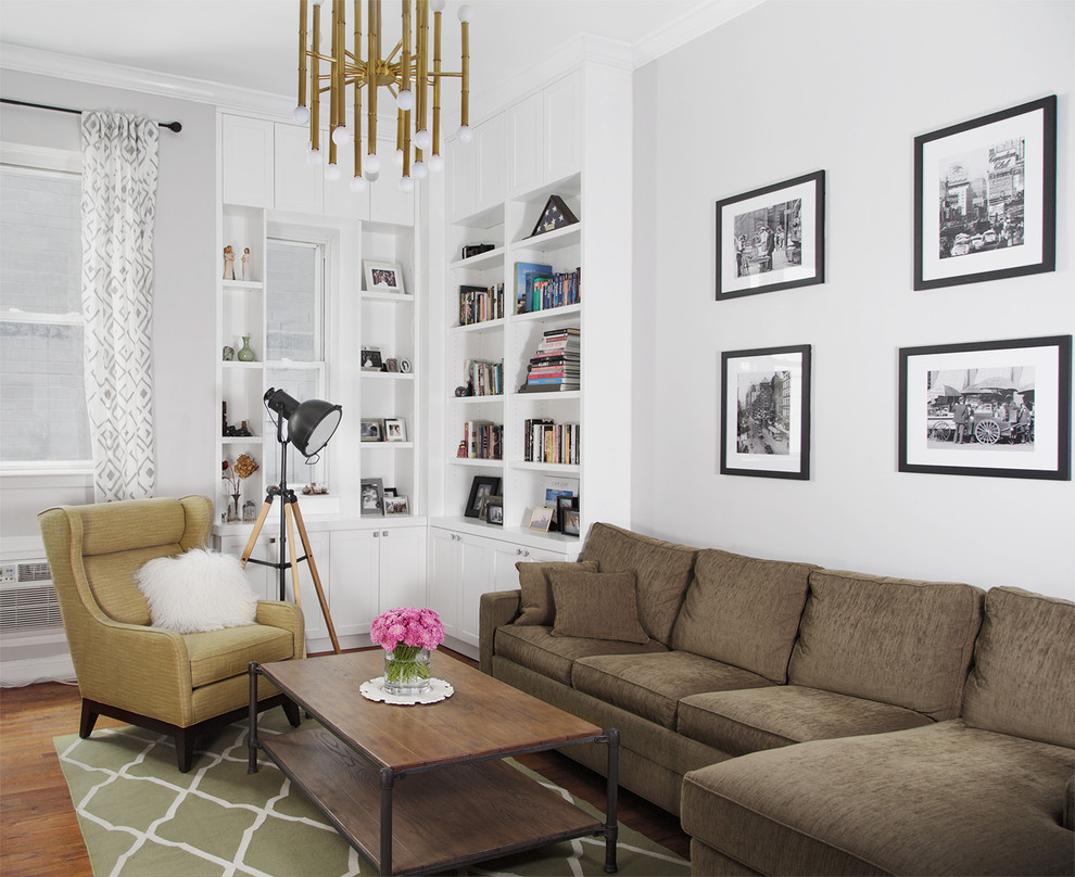 Example of a small transitional enclosed medium tone wood floor living room library design in New York with white walls, a standard fireplace, a tile fireplace and a tv stand
