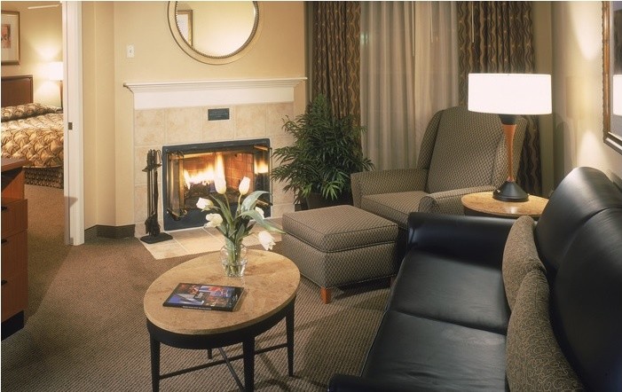 Small trendy enclosed carpeted living room photo in DC Metro with beige walls, a standard fireplace, a tile fireplace and no tv