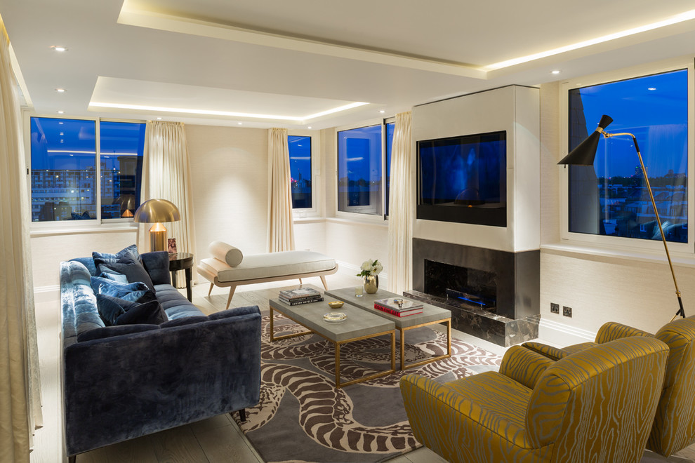 Photo of a contemporary open plan living room in London with white walls, a concealed tv and beige floors.