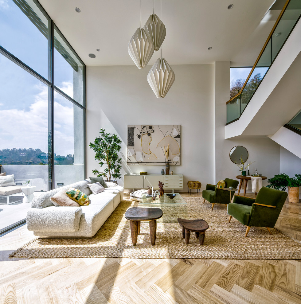 Living room - contemporary open concept light wood floor and beige floor living room idea in Los Angeles with white walls