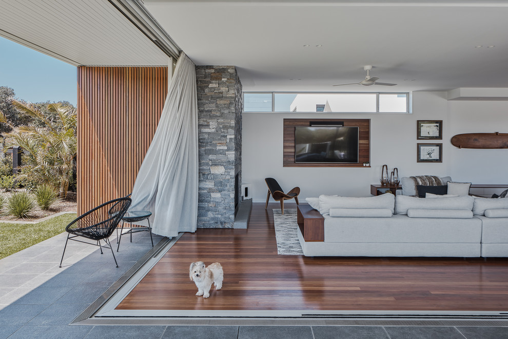 Inspiration for a contemporary open concept dark wood floor and brown floor living room remodel in Gold Coast - Tweed with white walls and a wall-mounted tv