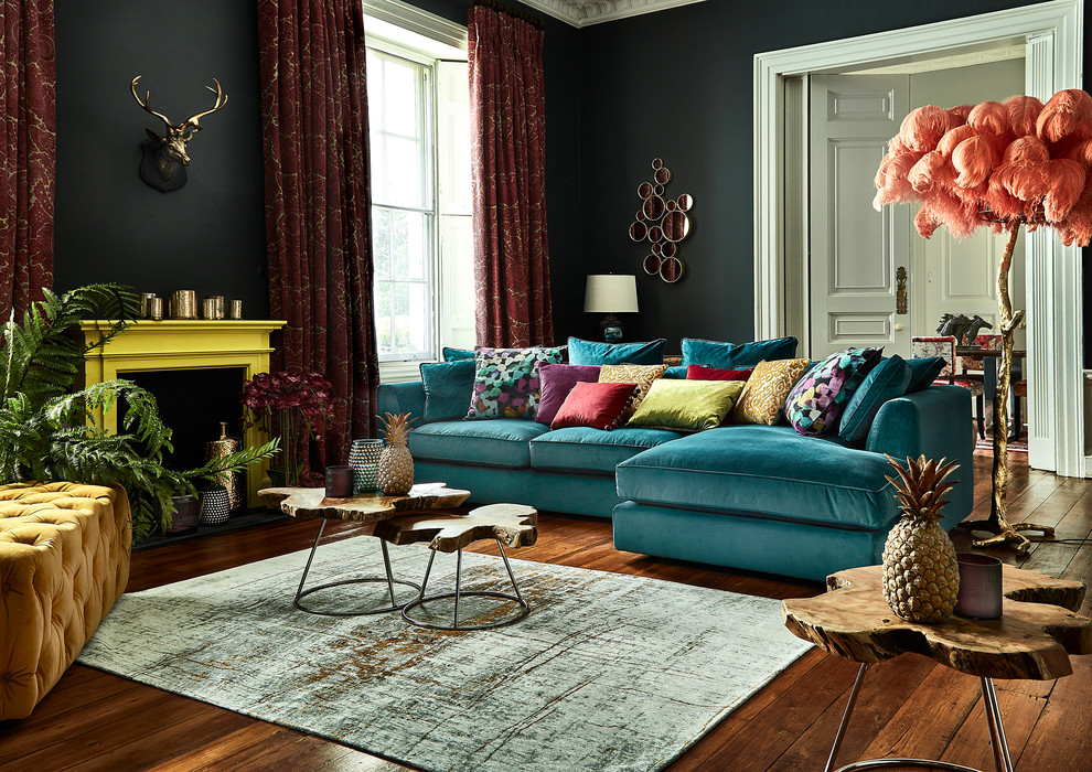 Living room - mid-sized eclectic enclosed dark wood floor living room idea in Cork with a standard fireplace, blue walls and a plaster fireplace