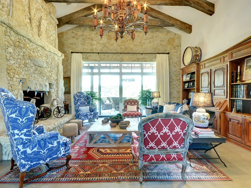 Design ideas for a large eclectic open plan living room in Austin with white walls, a two-sided fireplace, a stone fireplace surround, a built-in media unit and beige floors.