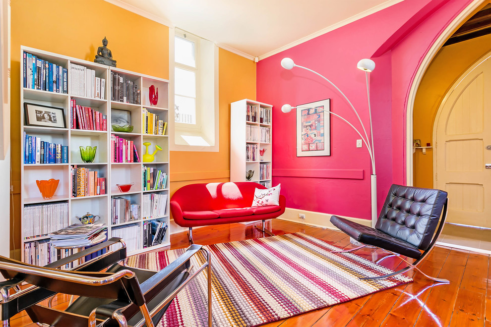 Example of a large eclectic open concept light wood floor living room library design in Adelaide with multicolored walls
