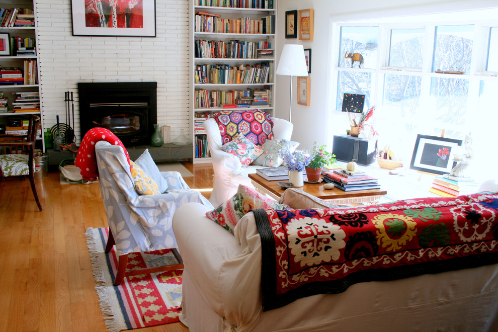 Eclectic living room photo in Burlington with a brick fireplace