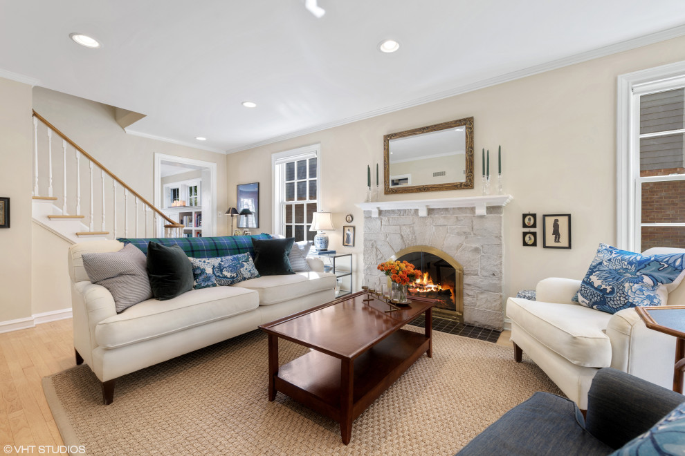 Design ideas for a traditional living room in Chicago with beige walls, a standard fireplace and a stone fireplace surround.