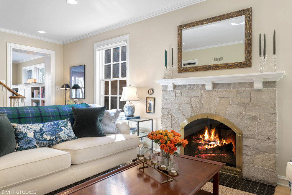 Inspiration for a classic living room in Chicago with beige walls, a standard fireplace and a stone fireplace surround.