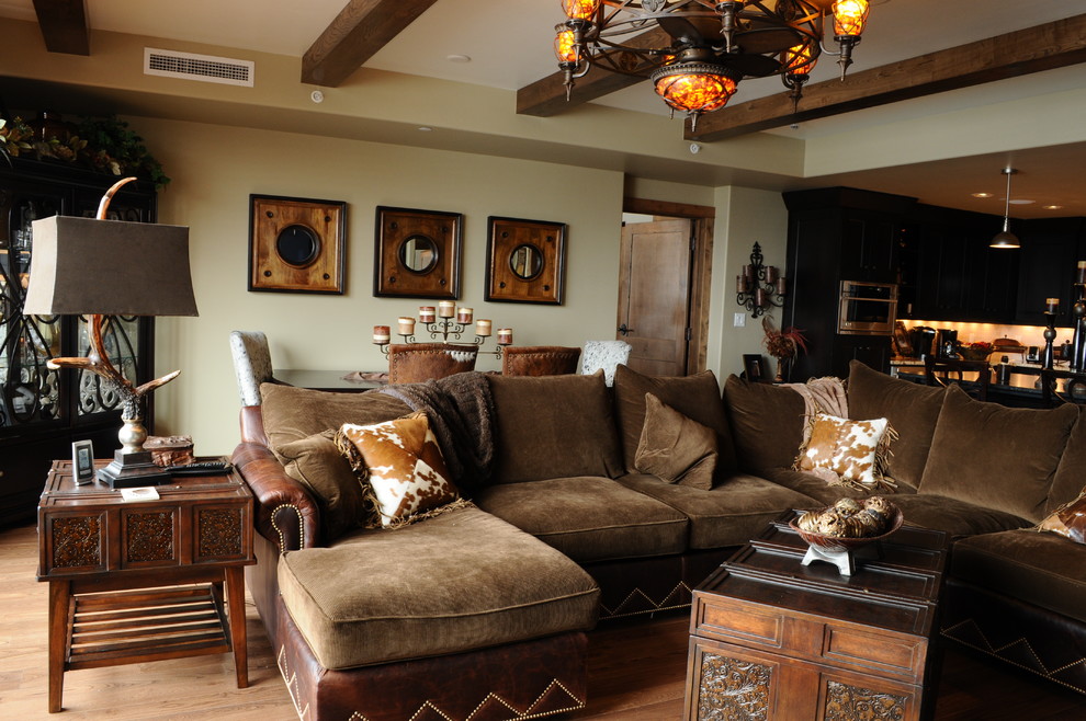 Example of a mid-sized mountain style open concept light wood floor living room design in Denver with beige walls