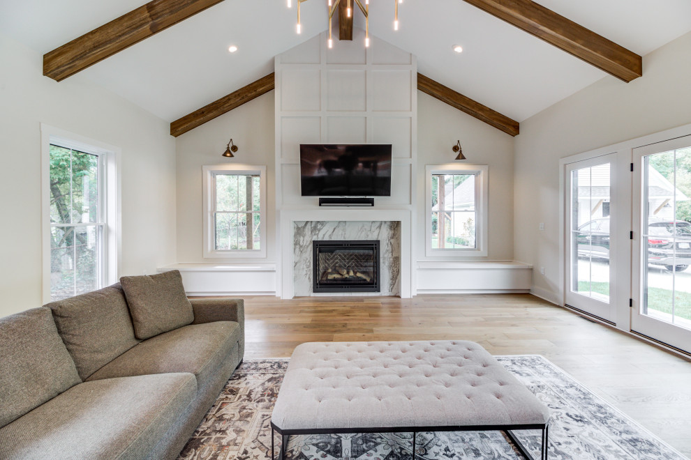 Example of a transitional light wood floor and exposed beam living room design in Cleveland with gray walls, a standard fireplace, a tile fireplace and a wall-mounted tv